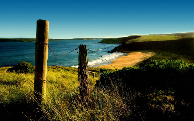 Wooden fence grassy hill ocean free wallpaper for desktop - medium preview image
