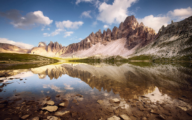 Mountain lake rocks grass cloudy free wallpaper for desktop - medium preview image