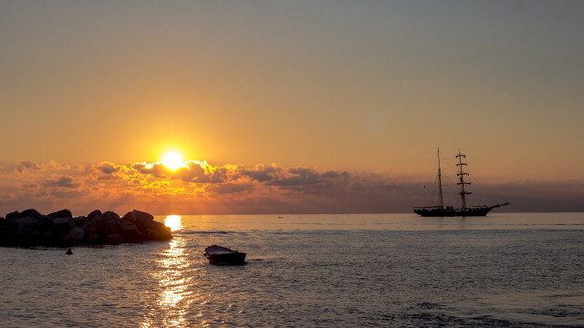 Boat ocean sunset rock mountain free wallpaper for desktop - medium preview image