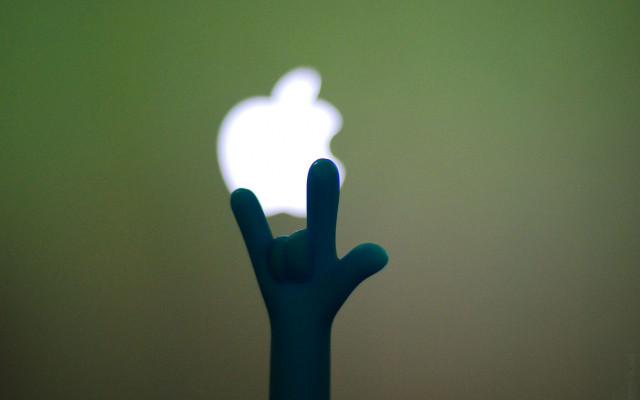 Hand holding apple logo green free wallpaper for desktop - medium preview image