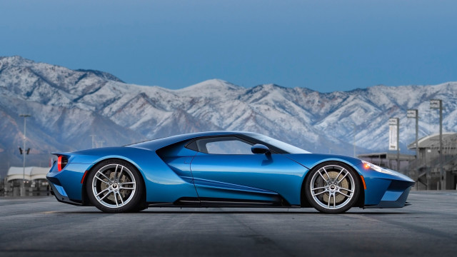 Blue sports car mountains sky free wallpaper for desktop - medium preview image