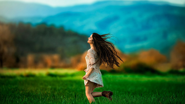 Woman field blowing hair mountains free wallpaper for desktop - medium preview image