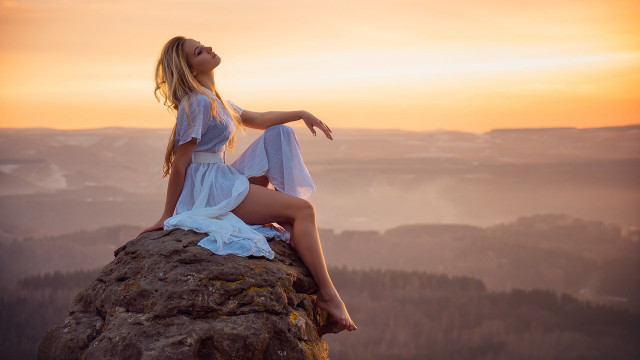 Woman sitting rock beach sunset free wallpaper for desktop - medium preview image
