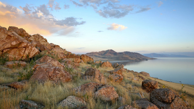 Rocky hillside lake clouds grass free wallpaper for desktop - medium preview image