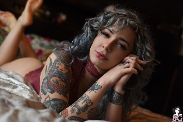 Tattooed woman bed bokeh photorealistic free wallpaper for desktop - medium preview image
