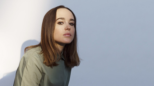 Woman green shirt serious portrait free wallpaper for desktop - medium preview image