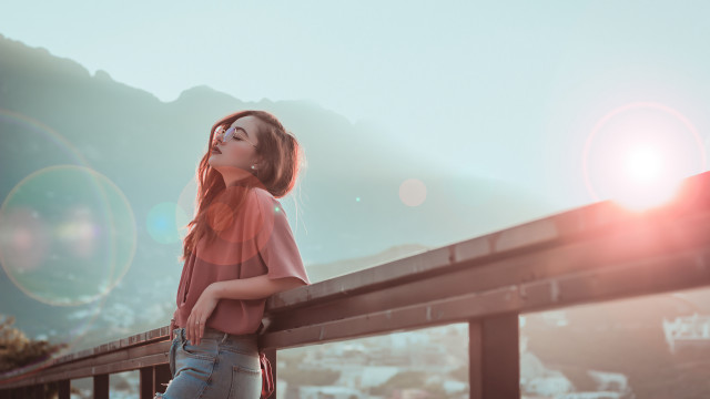 Woman leaning rail blowing hair free wallpaper for desktop - medium preview image