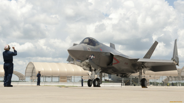 Fighterjet man suit tarmac cloudy free wallpaper for desktop - medium preview image