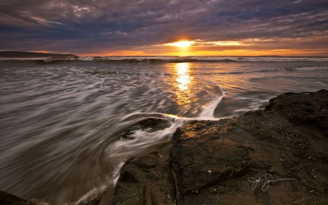 Sunset ocean waves rock shore free wallpaper for desktop - medium preview image