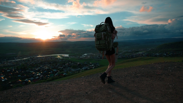Woman backpack hill sunset town #2 free wallpaper for desktop - medium preview image