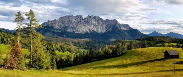 Grassy field house mountains clouds free wallpaper for desktop - medium preview image