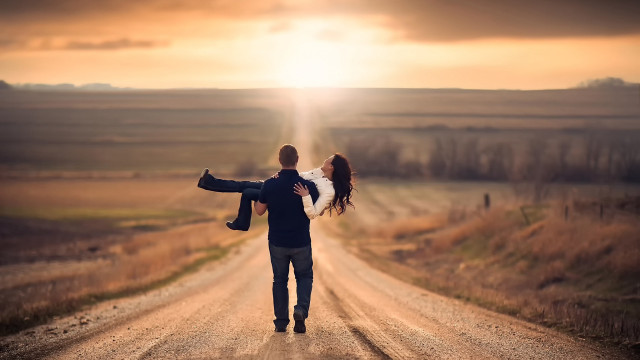 Romantic man carrying woman dirt free wallpaper for desktop - medium preview image