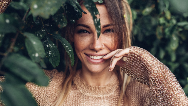 Woman smiling greenplant portrait photorealistic free wallpaper for desktop - medium preview image