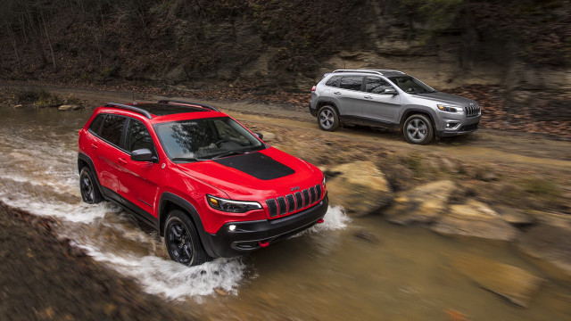 Two vehicles muddy road forest free wallpaper for desktop - medium preview image