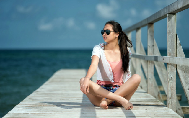 Woman pier sitting blurry beach free wallpaper for desktop - medium preview image