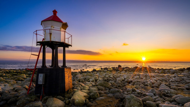 Lighthouse rocky beach sunset ocean free wallpaper for desktop - medium preview image