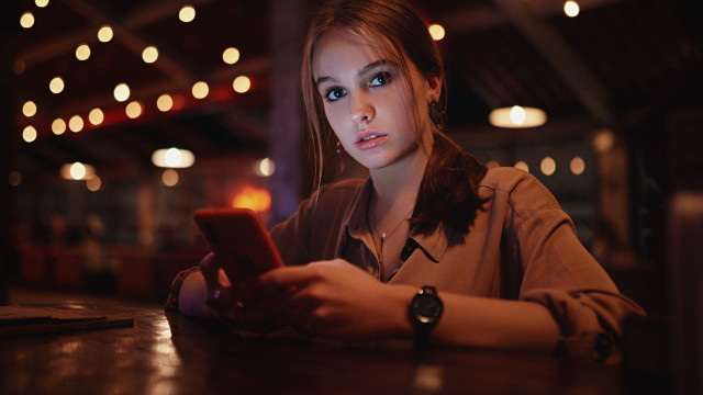 Woman serious cellphone table lights free wallpaper for desktop - medium preview image