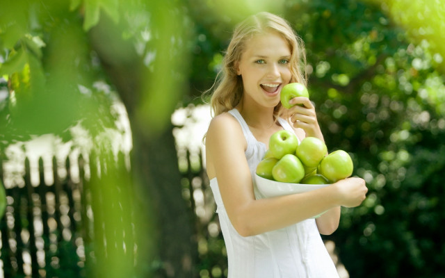 Woman green apples smile outdoors free wallpaper for desktop - medium preview image