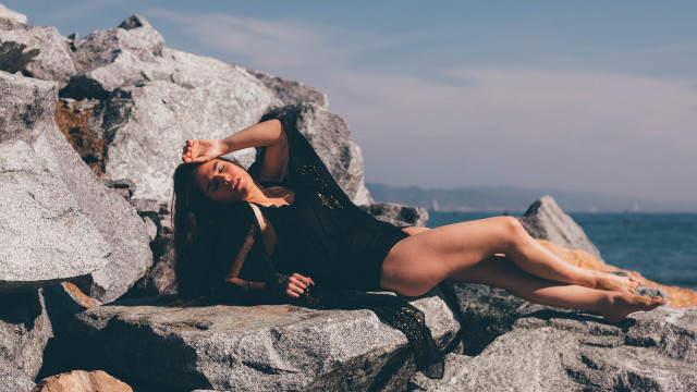 Woman rocks ocean crossed olive free wallpaper for desktop - medium preview image