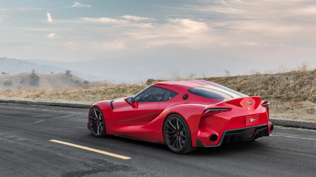 Red sports car hill sky free wallpaper for desktop - medium preview image