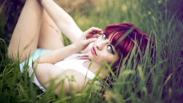 Woman lying in grass blooming free wallpaper for desktop - medium preview image