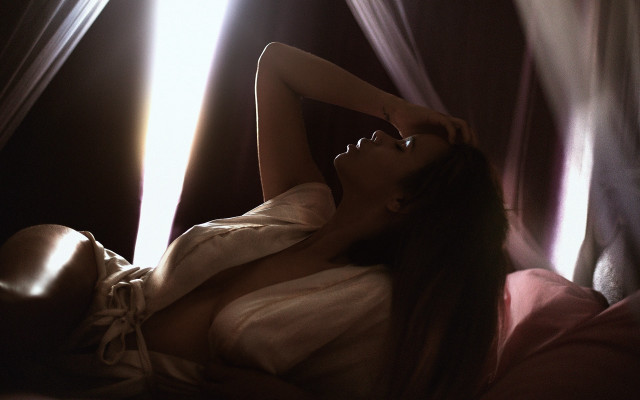 Woman lying bed blowing hair free wallpaper for desktop - medium preview image