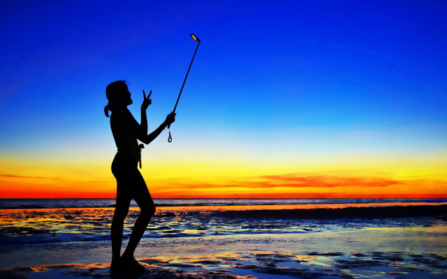 Woman beach fishing sunset vibrant free wallpaper for desktop - medium preview image
