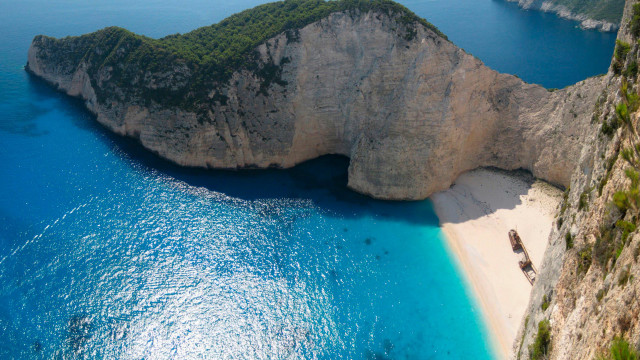 Beach rock formation boat cliff free wallpaper for desktop - medium preview image