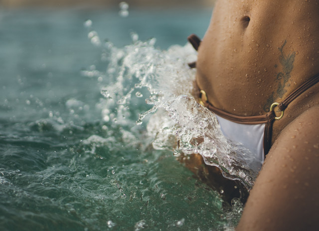 Woman bikini water hands pockets free wallpaper for desktop - medium preview image