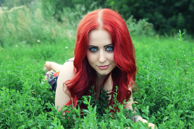 Redhair woman laying grass smiling free wallpaper for desktop - medium preview image