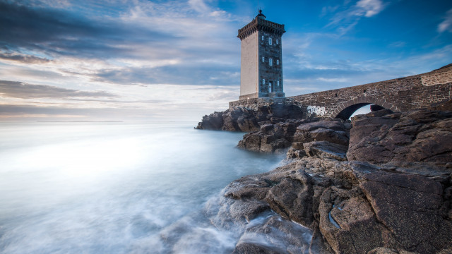 Lighthouse rocky shore bridge clouds free wallpaper for desktop - medium preview image