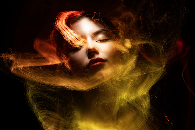 Woman blowing fire embers portrait free wallpaper for desktop - medium preview image