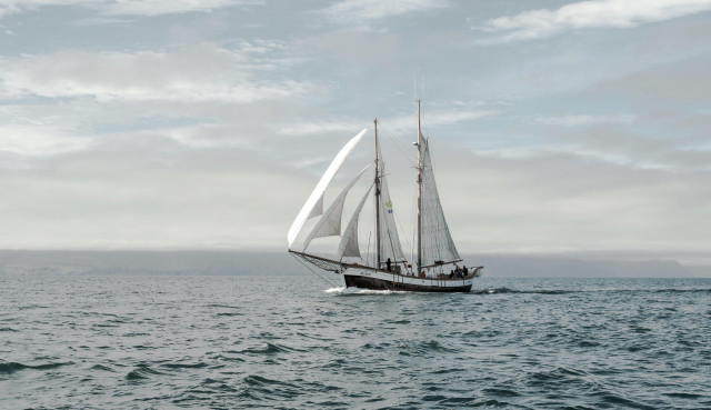 Sailboat ocean cloudy sky mountain free wallpaper for desktop - medium preview image