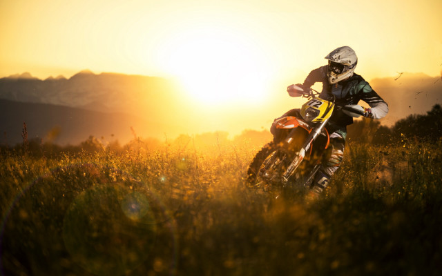Dirt bike riding grassy field #2 free wallpaper for desktop - medium preview image