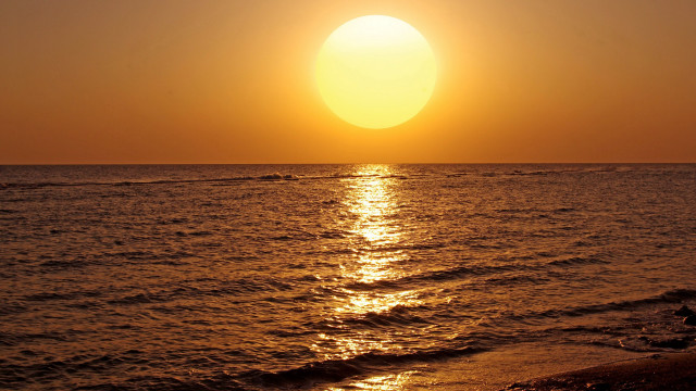 Sunset ocean surfer boat shore free wallpaper for desktop - medium preview image