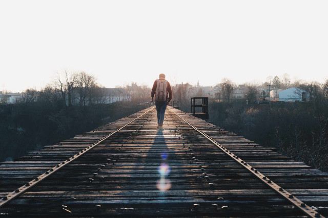 Man walking train track sunshine free wallpaper for desktop - medium preview image