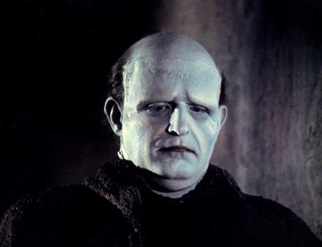 Bald man black sweater serious free wallpaper for desktop - medium preview image