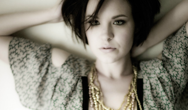 Woman necklace posing hands behind free wallpaper for desktop - medium preview image