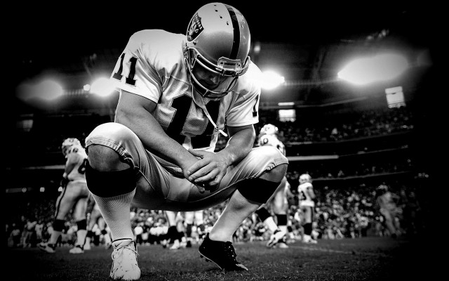 Football player kneeling field crowd free wallpaper for desktop - medium preview image