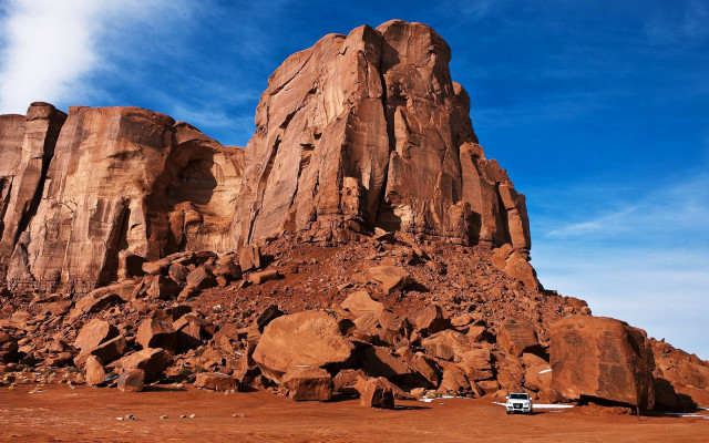 Car parked rock formation desert free wallpaper for desktop - medium preview image