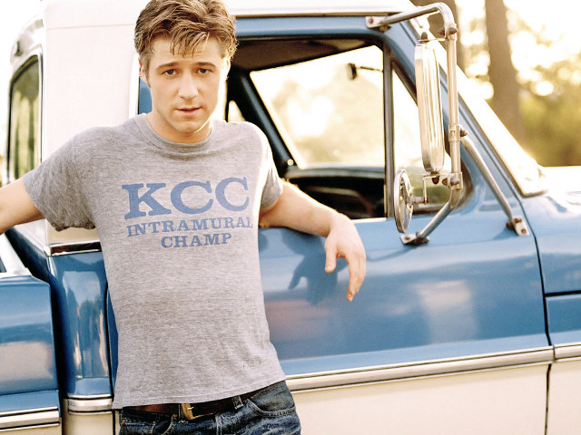 Man leaning truck door handle free wallpaper for desktop - medium preview image