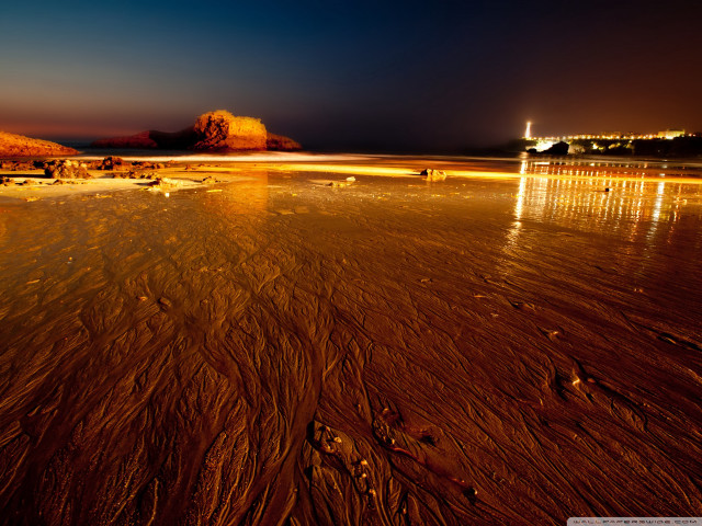 Beach night people lighthouse distance free wallpaper for desktop - medium preview image