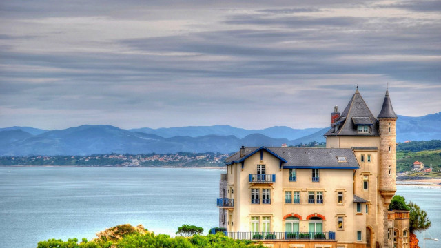 Large building tower water mountains free wallpaper for desktop - medium preview image