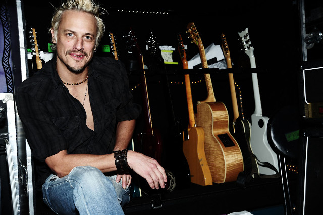 Man sitting guitar store portrait free wallpaper for desktop - medium preview image