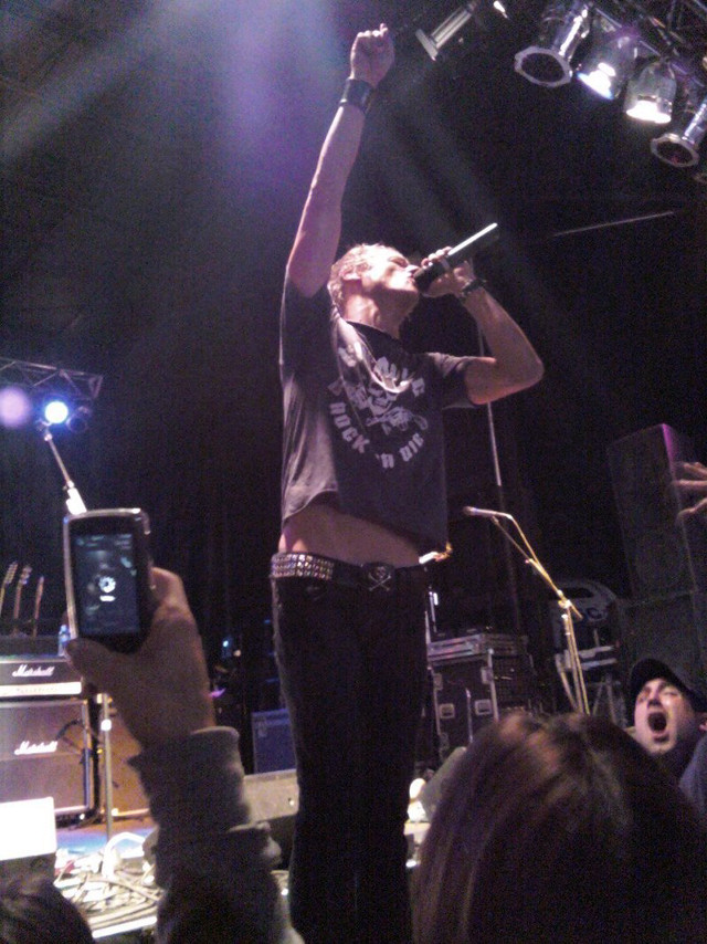 Man holding microphone stage audience free wallpaper for mobile - medium preview image