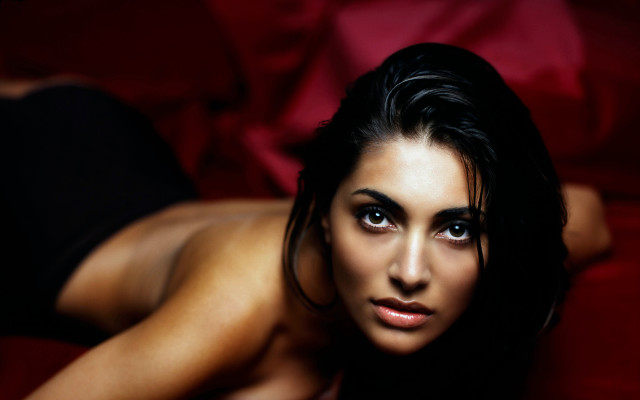 Woman laying red couch blurry free wallpaper for desktop - medium preview image