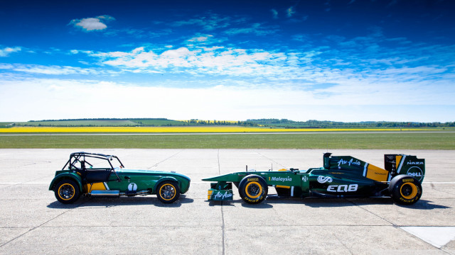 Green race cars parked tarmac free wallpaper for desktop - medium preview image
