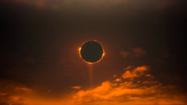 Solar eclipse clouds orange glow free wallpaper for desktop - medium preview image