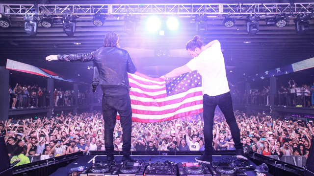 Men holding flag stage crowd free wallpaper for desktop - medium preview image
