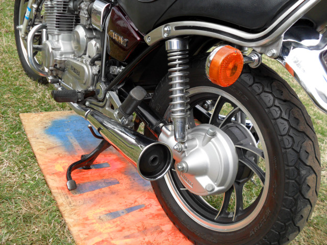 Motorcycle parked grass red light free wallpaper for desktop - medium preview image